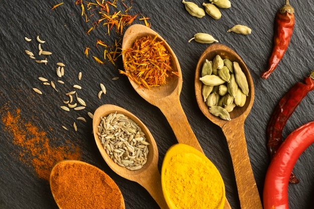 top-view-indian-spices-with-wooden-spoons_23-2148747650